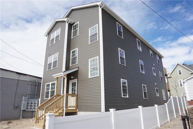 rear view of house featuring a fenced front yard