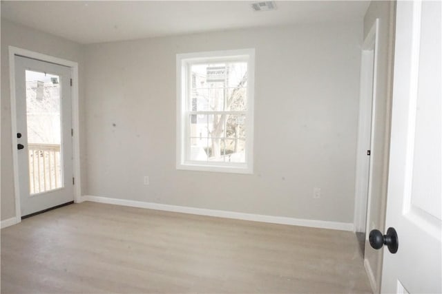 foyer entrance with light wood-type flooring, visible vents, and baseboards