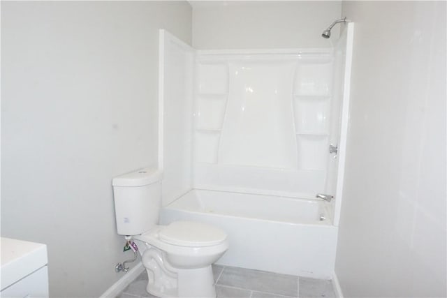 bathroom featuring vanity, tile patterned floors, toilet, and shower / washtub combination