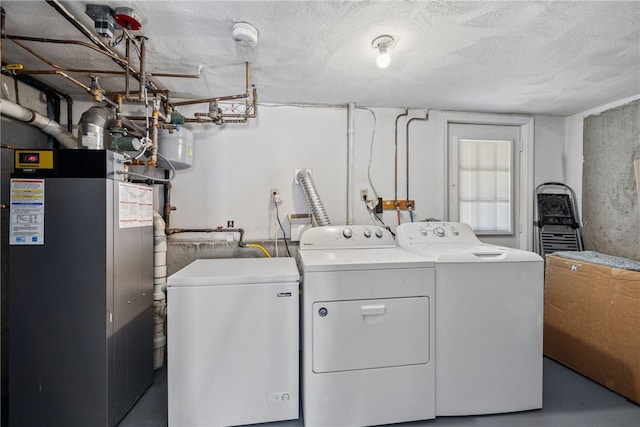 washroom featuring a textured ceiling and separate washer and dryer