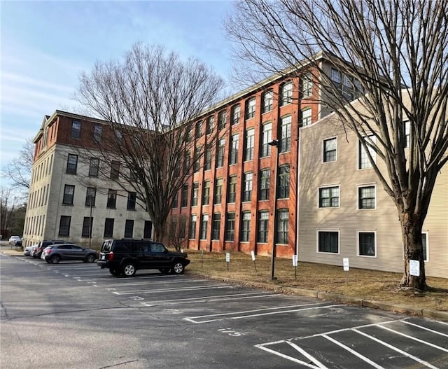 view of building exterior with uncovered parking