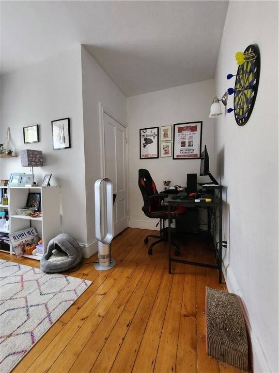 office featuring baseboards and hardwood / wood-style flooring