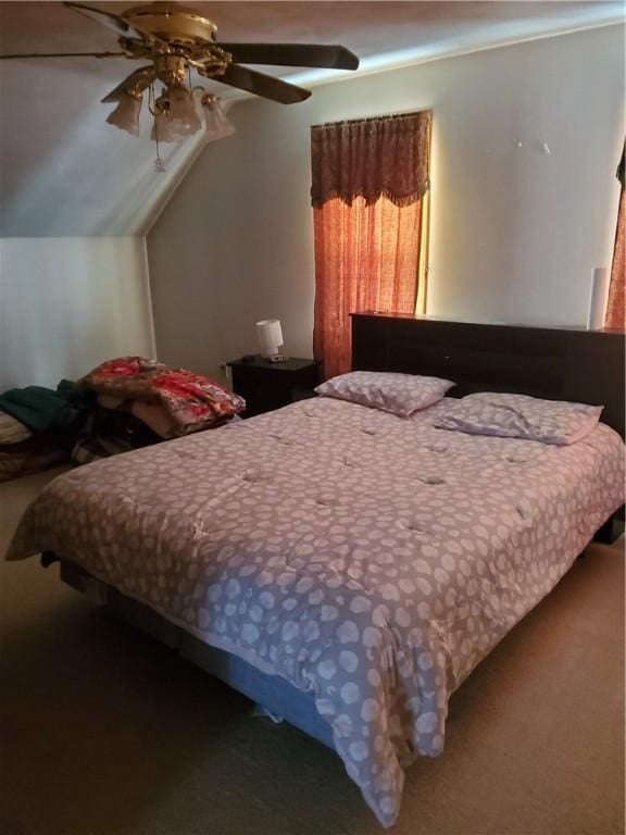 bedroom with carpet flooring, a ceiling fan, and vaulted ceiling