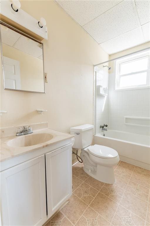 full bath featuring toilet, shower / tub combination, tile patterned flooring, a paneled ceiling, and vanity