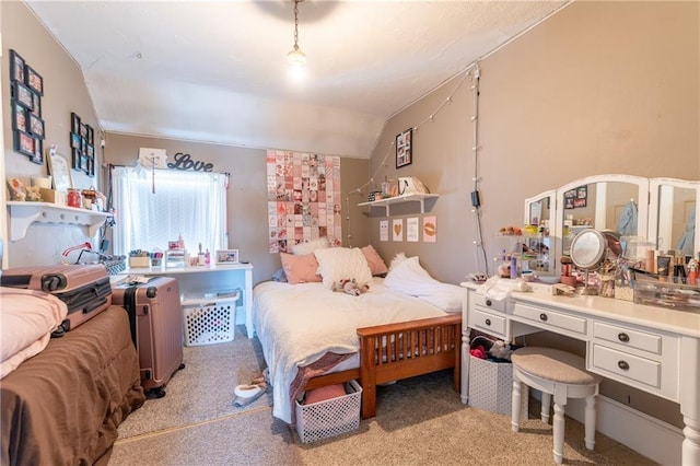 bedroom with vaulted ceiling and light colored carpet