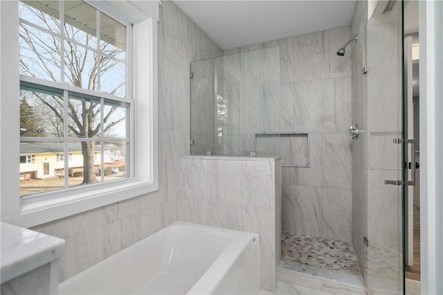 bathroom with a bath and a stall shower