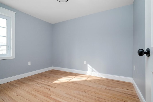 empty room with wood finished floors and baseboards