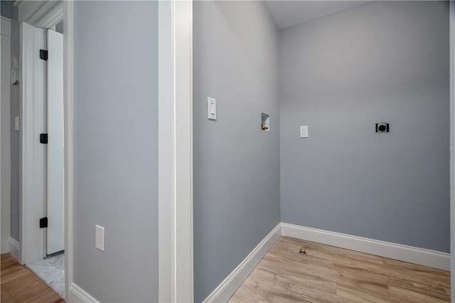 clothes washing area with laundry area, baseboards, light wood-type flooring, and hookup for an electric dryer