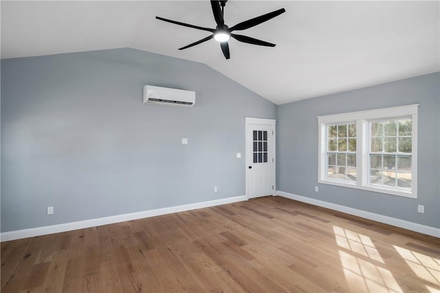 unfurnished room featuring light wood finished floors, a wall mounted air conditioner, and a ceiling fan