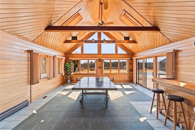 unfurnished sunroom featuring a ceiling fan, vaulted ceiling with beams, wood ceiling, and baseboard heating