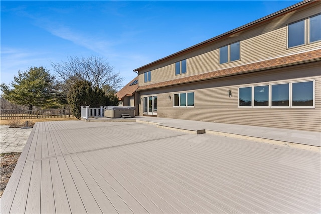 wooden deck with fence and a hot tub