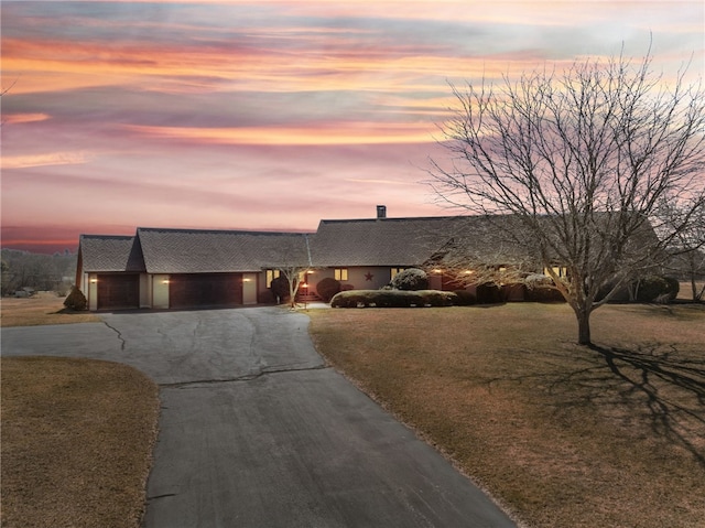 view of front of house with driveway and a front yard