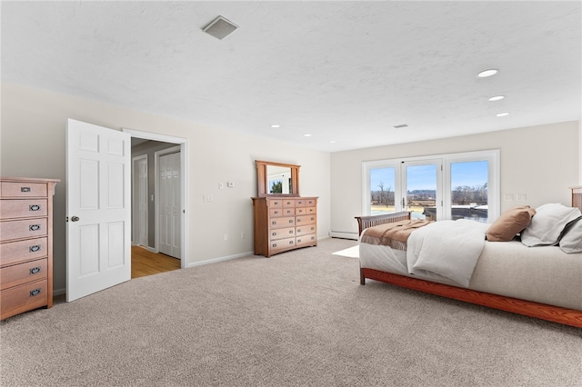 bedroom with a textured ceiling, recessed lighting, baseboards, and light carpet