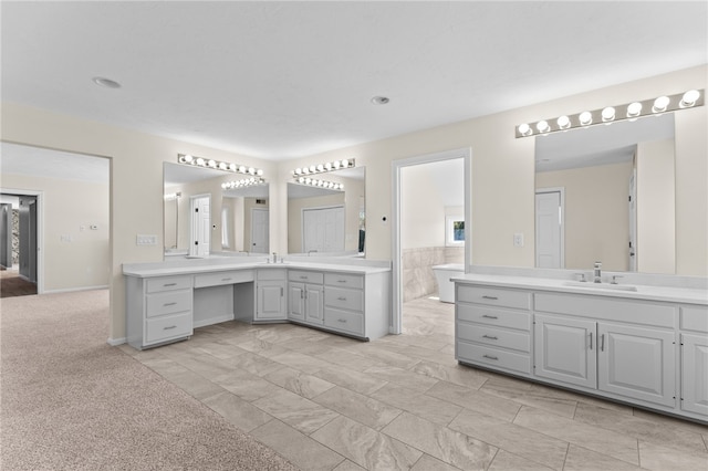 bathroom featuring a sink and two vanities