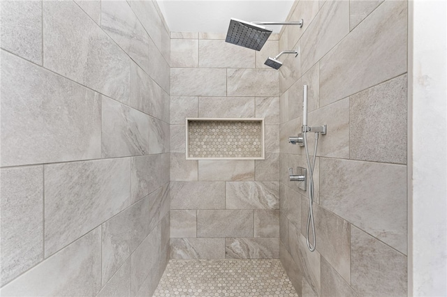 bathroom with tiled shower