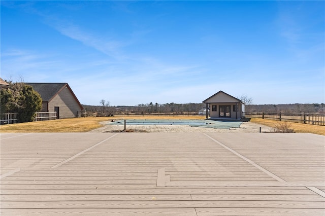 view of swimming pool featuring fence