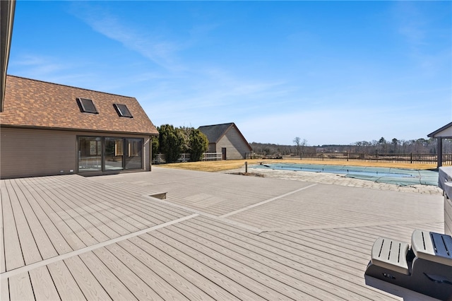 wooden deck featuring a fenced in pool and fence