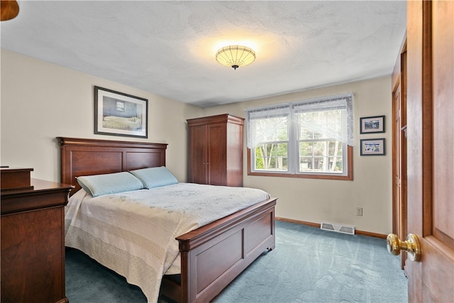 bedroom with baseboards, visible vents, carpet floors, and a textured ceiling