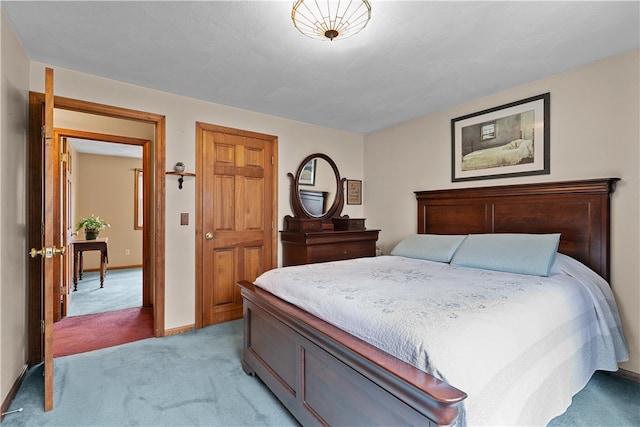 bedroom with light carpet and baseboards