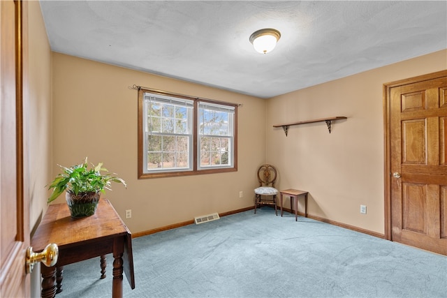 living area featuring carpet, visible vents, and baseboards