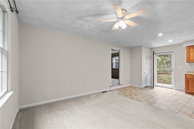 empty room featuring light carpet, recessed lighting, baseboards, and ceiling fan