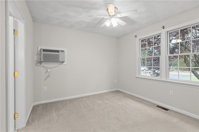 unfurnished room featuring visible vents, light colored carpet, baseboards, and ceiling fan