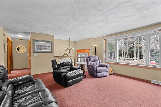 carpeted living room with visible vents, a textured ceiling, baseboards, and an inviting chandelier