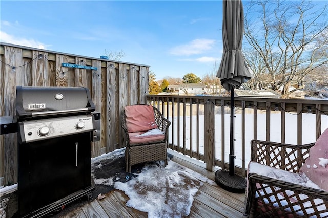 snow covered deck with grilling area