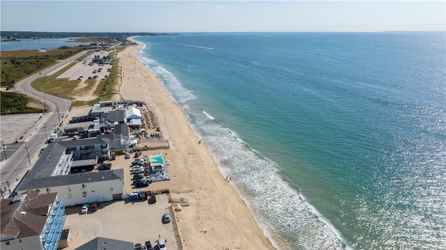 drone / aerial view featuring a beach view and a water view