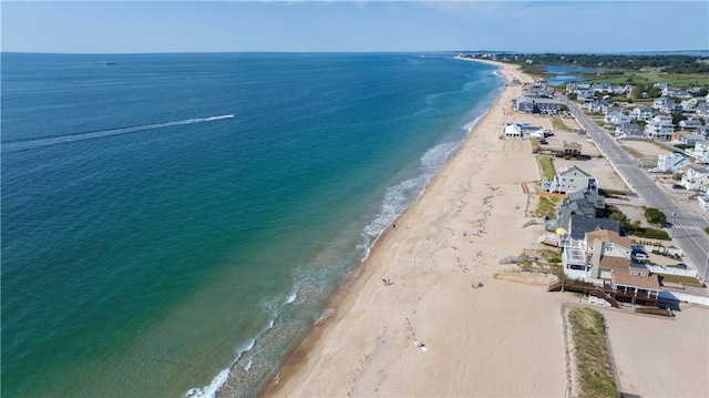 birds eye view of property with a beach view and a water view