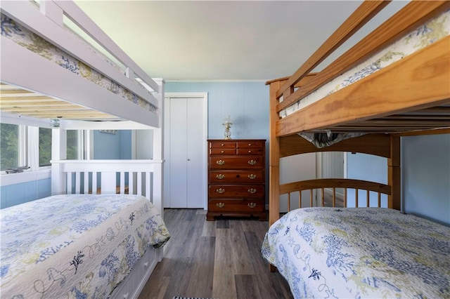 bedroom featuring a closet and dark wood-style flooring