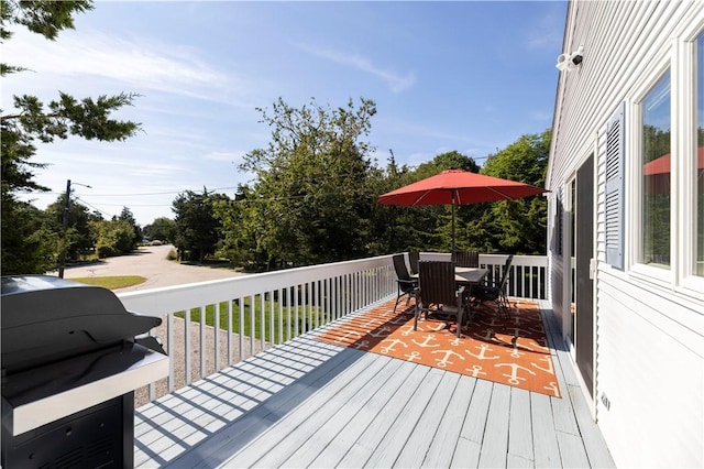 deck featuring area for grilling and outdoor dining space