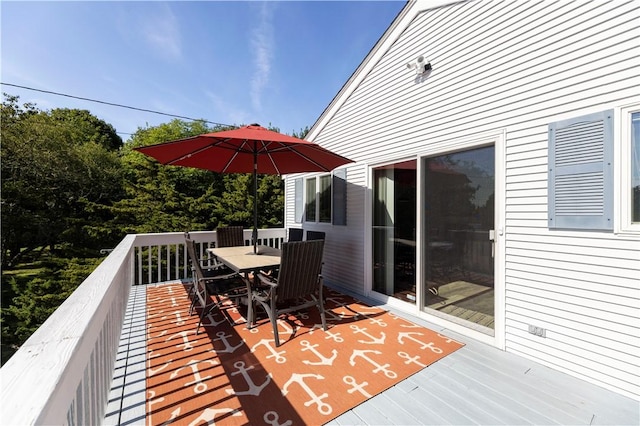 wooden terrace with outdoor dining area