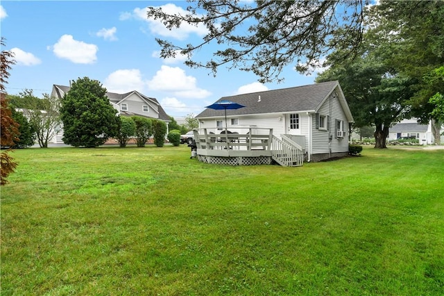 back of property with a lawn and a deck