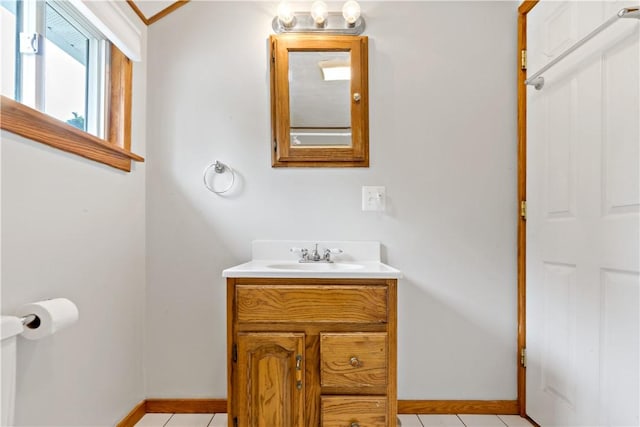 bathroom with tile patterned floors, vanity, and baseboards