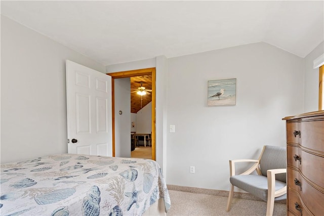 bedroom with carpet flooring and lofted ceiling