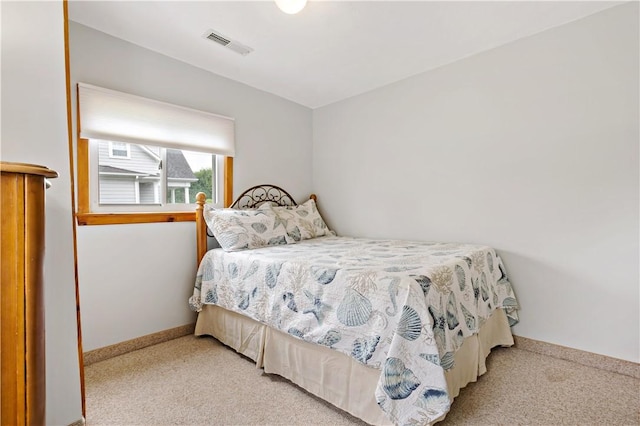 bedroom featuring visible vents, baseboards, and carpet floors