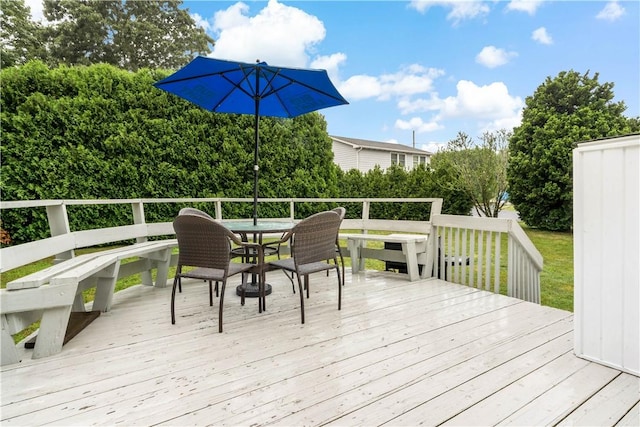 wooden terrace with outdoor dining area