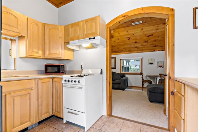 86 Winnapaug Rd, Westerly, RI 02891 - kitchen featuring under cabinet range hood, white range with gas stovetop, light brown cabinetry, and lofted ceiling