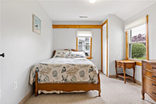 bedroom with visible vents, baseboards, carpet, and a closet