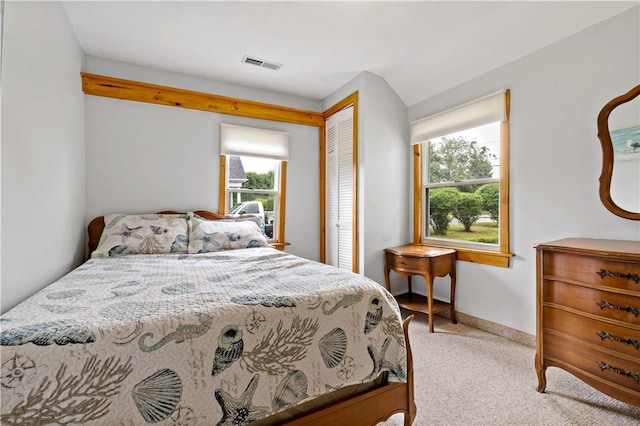 bedroom featuring a closet, visible vents, and carpet flooring