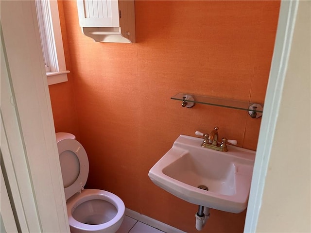 bathroom with toilet and a sink