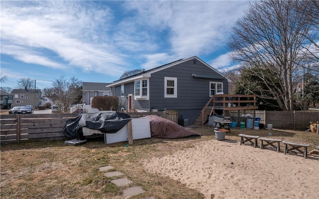 back of property featuring fence