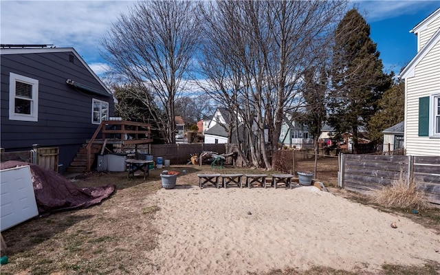 view of yard featuring stairs, fence private yard, and an outdoor fire pit