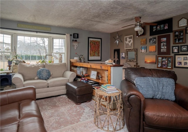 living area featuring a textured ceiling and ceiling fan