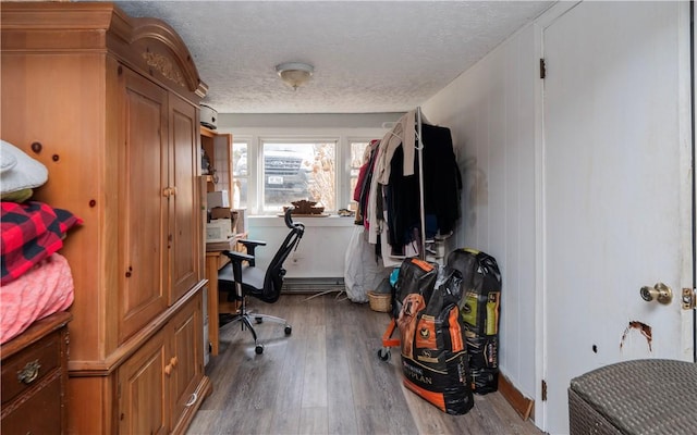 interior space featuring wood finished floors and a textured ceiling