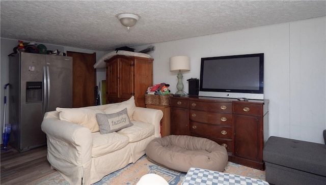 living area featuring a textured ceiling and light wood-type flooring