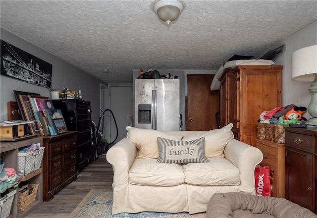 living room featuring a textured ceiling and wood finished floors