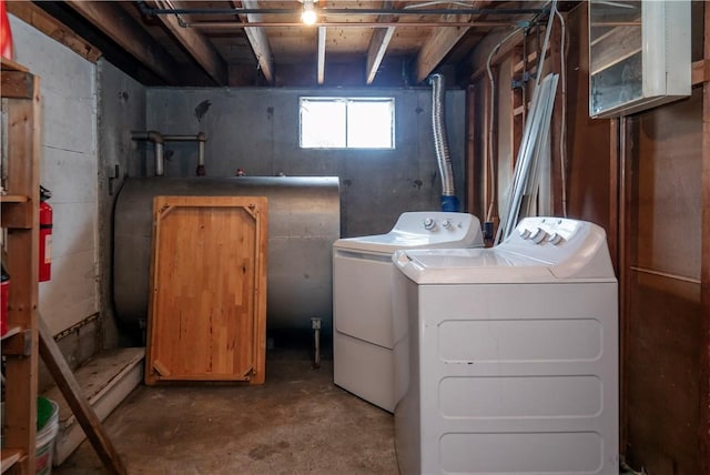laundry room featuring laundry area, heating fuel, and separate washer and dryer
