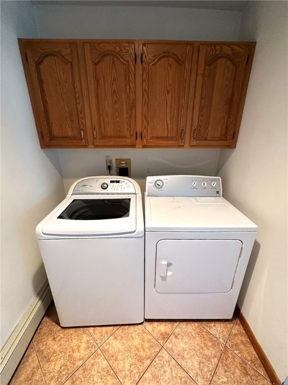 laundry area featuring cabinet space, light tile patterned floors, independent washer and dryer, and baseboards